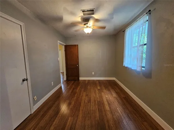 wooden floor in an empty room with a window