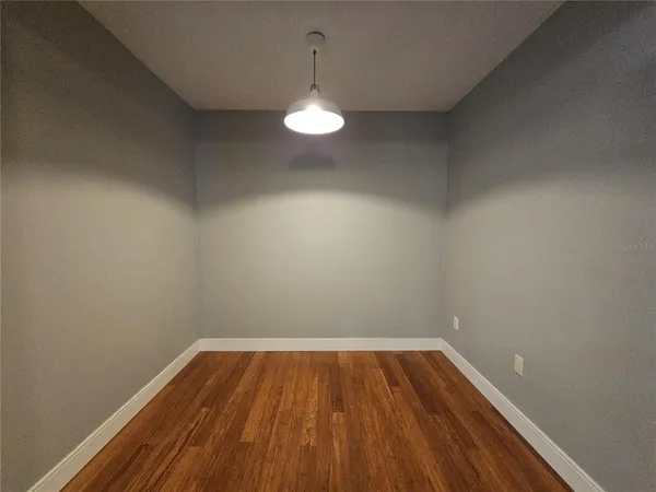 a view of room with wooden floor and fan