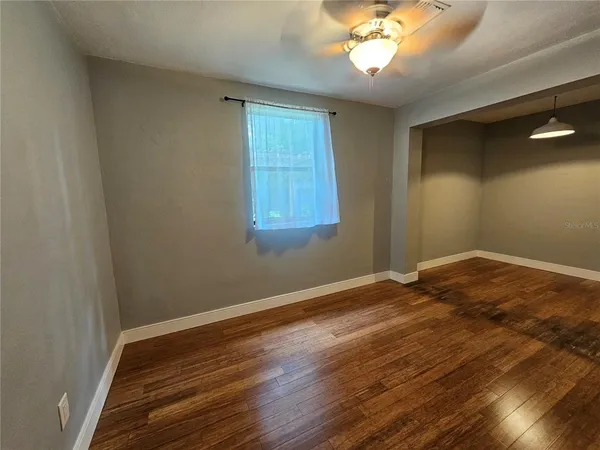 wooden floor in an empty room with a window