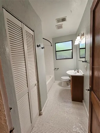 a bathroom with a sink a mirror and a shower