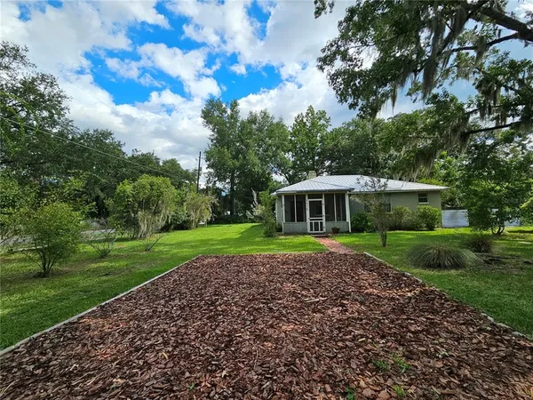 a view of an house with backyard space and garden