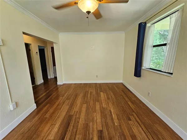 a view of a room with wooden floor and a window