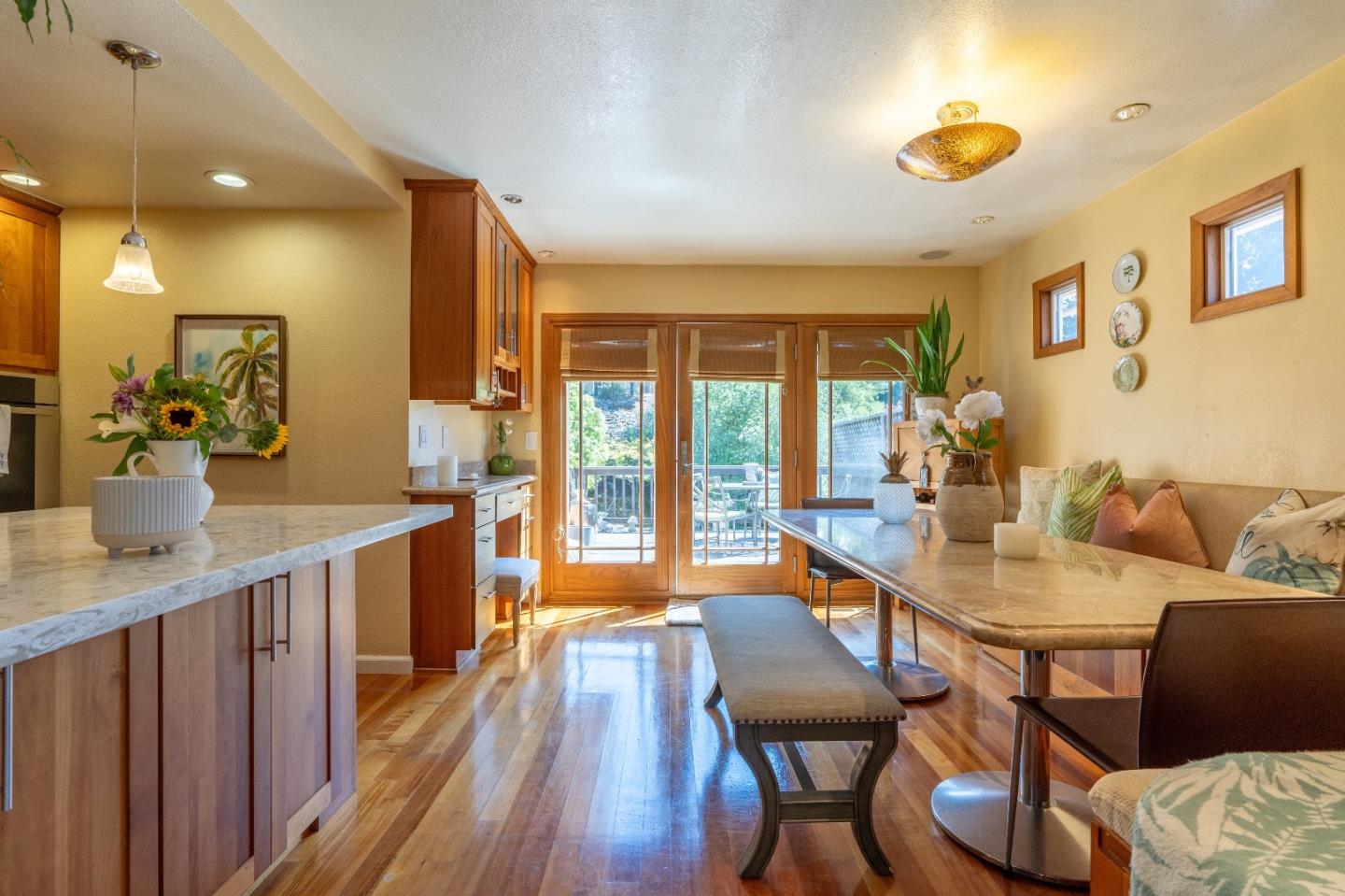 815 Cape Breton Drive Pacifica, CA 94044 - Photo 17 of 65 a view of a dining room and livingroom with furniture wooden floor a rug a potted plant and a chandelier