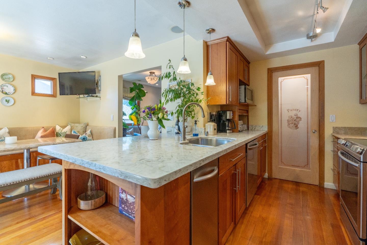 815 Cape Breton Drive Pacifica, CA 94044 - Photo 24 of 65 a kitchen with stainless steel appliances granite countertop a sink a stove and a wooden floor