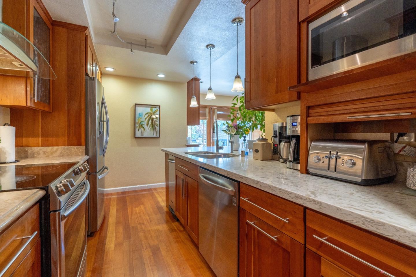 815 Cape Breton Drive Pacifica, CA 94044 - Photo 27 of 65 a kitchen with stainless steel appliances granite countertop a sink a stove and a wooden floors