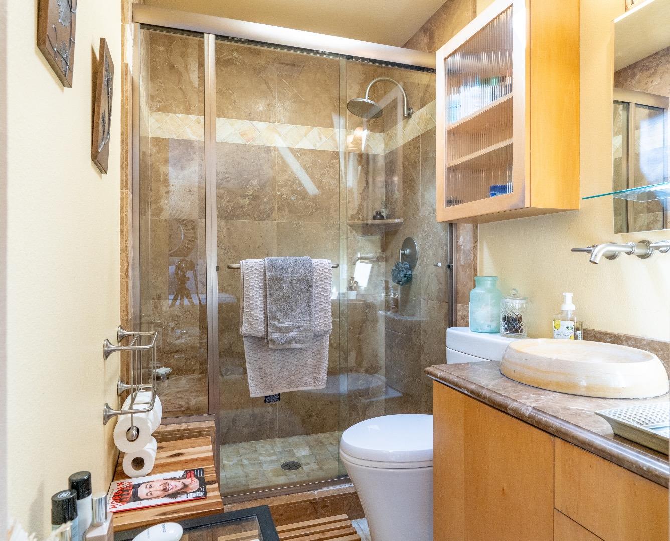 815 Cape Breton Drive Pacifica, CA 94044 - Photo 35 of 65 a bathroom with a granite countertop sink a toilet and shower