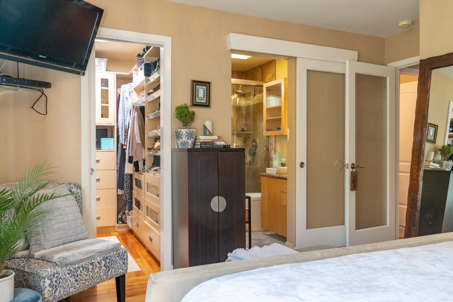 815 Cape Breton Drive Pacifica, CA 94044 - Photo 36 of 65 a bedroom with a bed and a chandelier