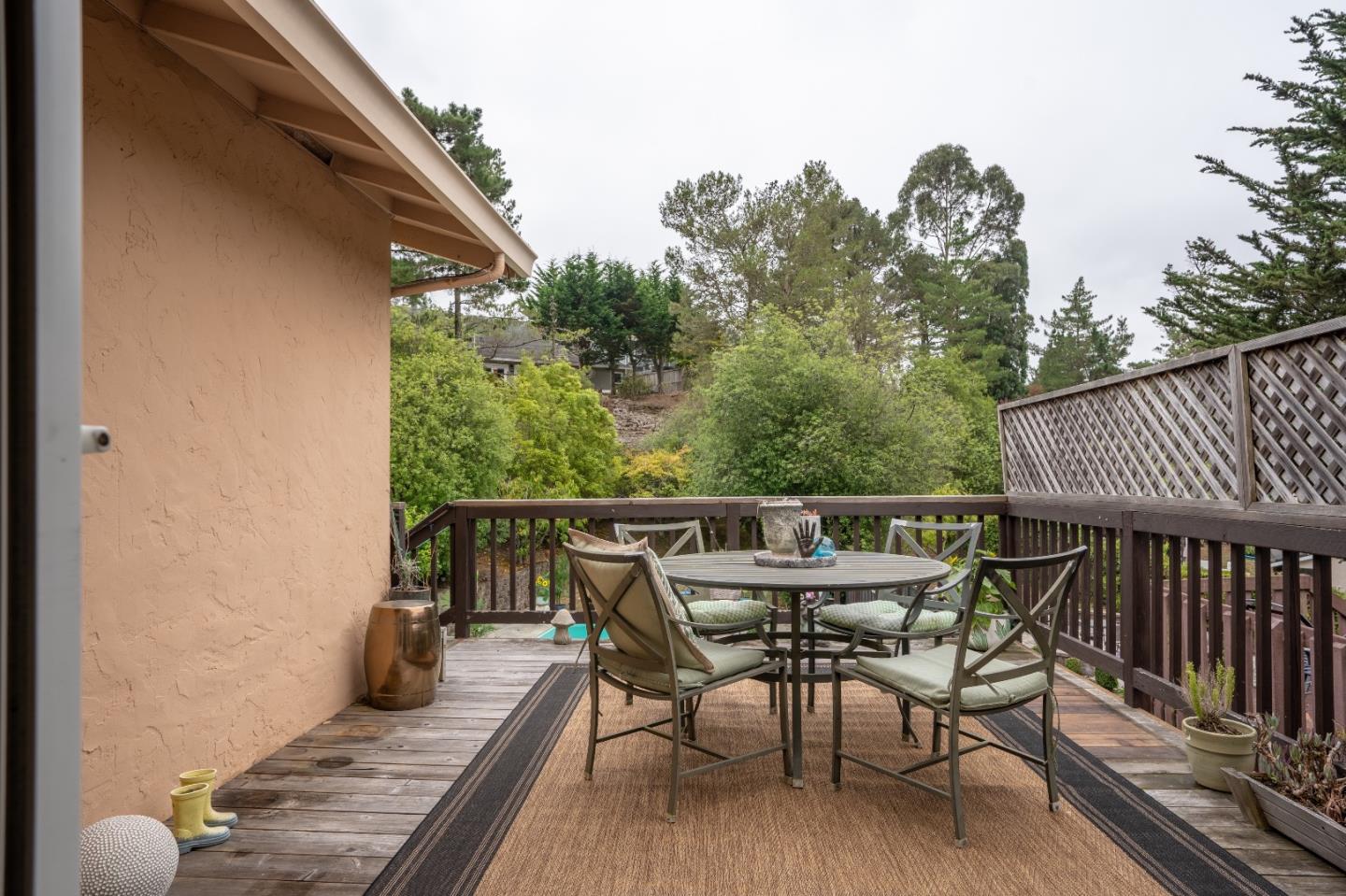 815 Cape Breton Drive Pacifica, CA 94044 - Photo 47 of 65 a view of a patio with table and chairs with wooden floor and fence