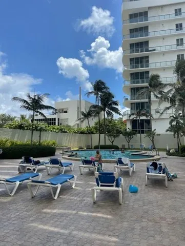 a view of a patio with couches and table and chairs and potted plants