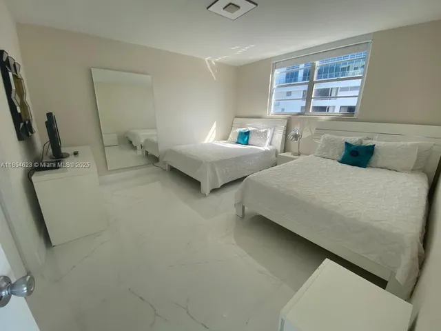 a bedroom with bed and window