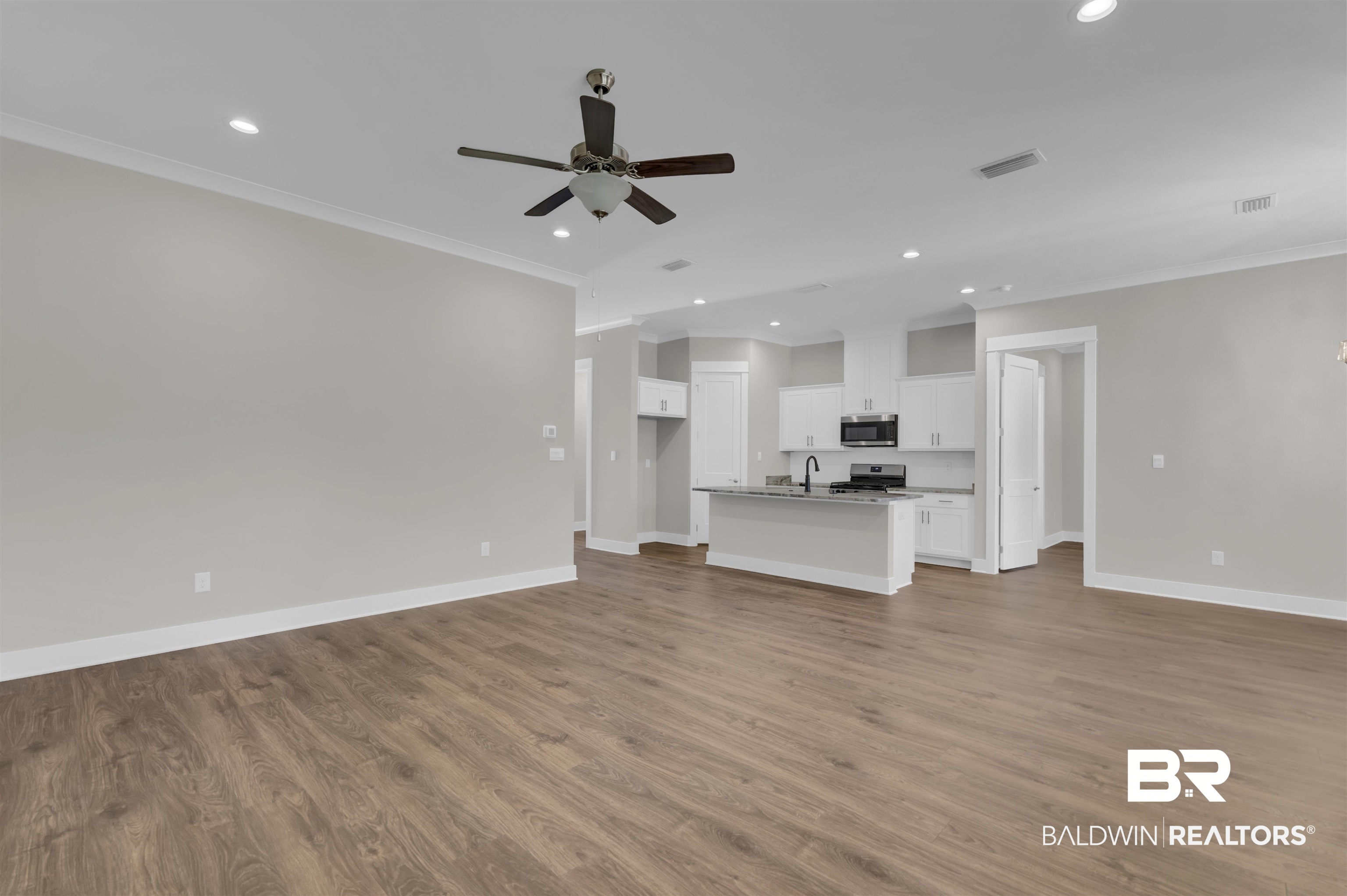 571 Morning Mist Way Fairhope, AL 36532 - Photo 14 of 47 Unfurnished living room featuring recessed lighting, ornamental molding, light wood finished floors, and ceiling fan