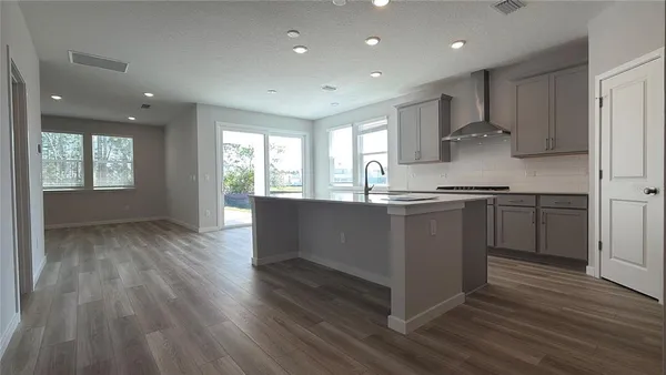 a kitchen with granite countertop white cabinets and a stove top oven