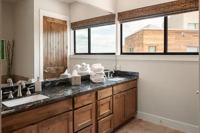 a kitchen with sink and large window