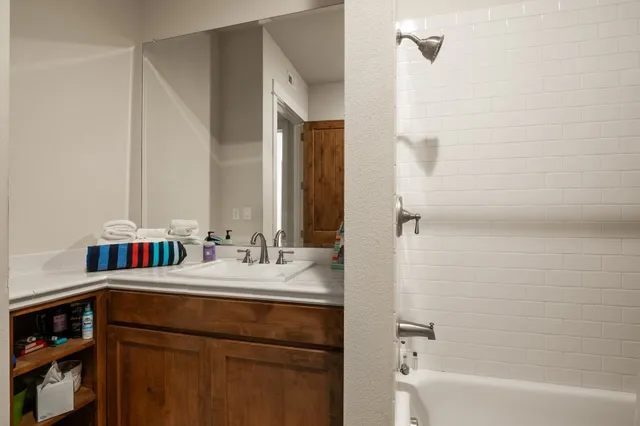 a bathroom with a bathtub and a sink