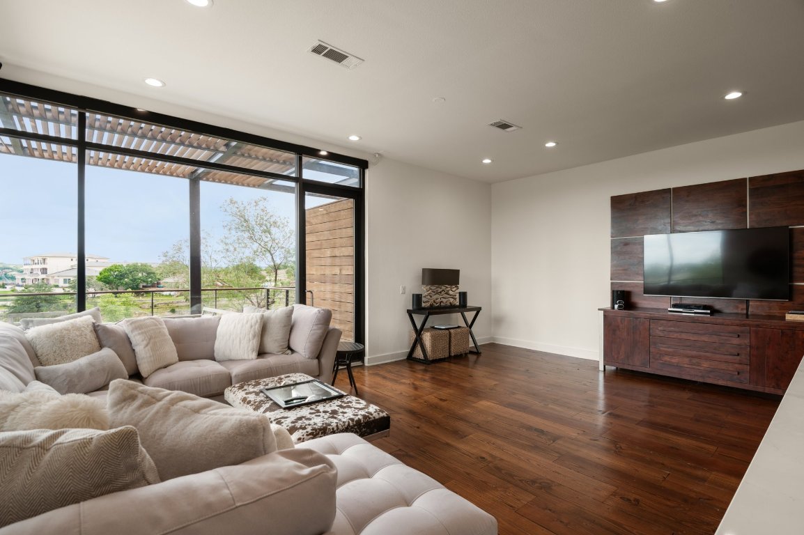 1101 Ivean Pearson Road, Unit E201 Leander, TX 78645 - Photo 17 of 20 a living room with furniture and a flat screen tv
