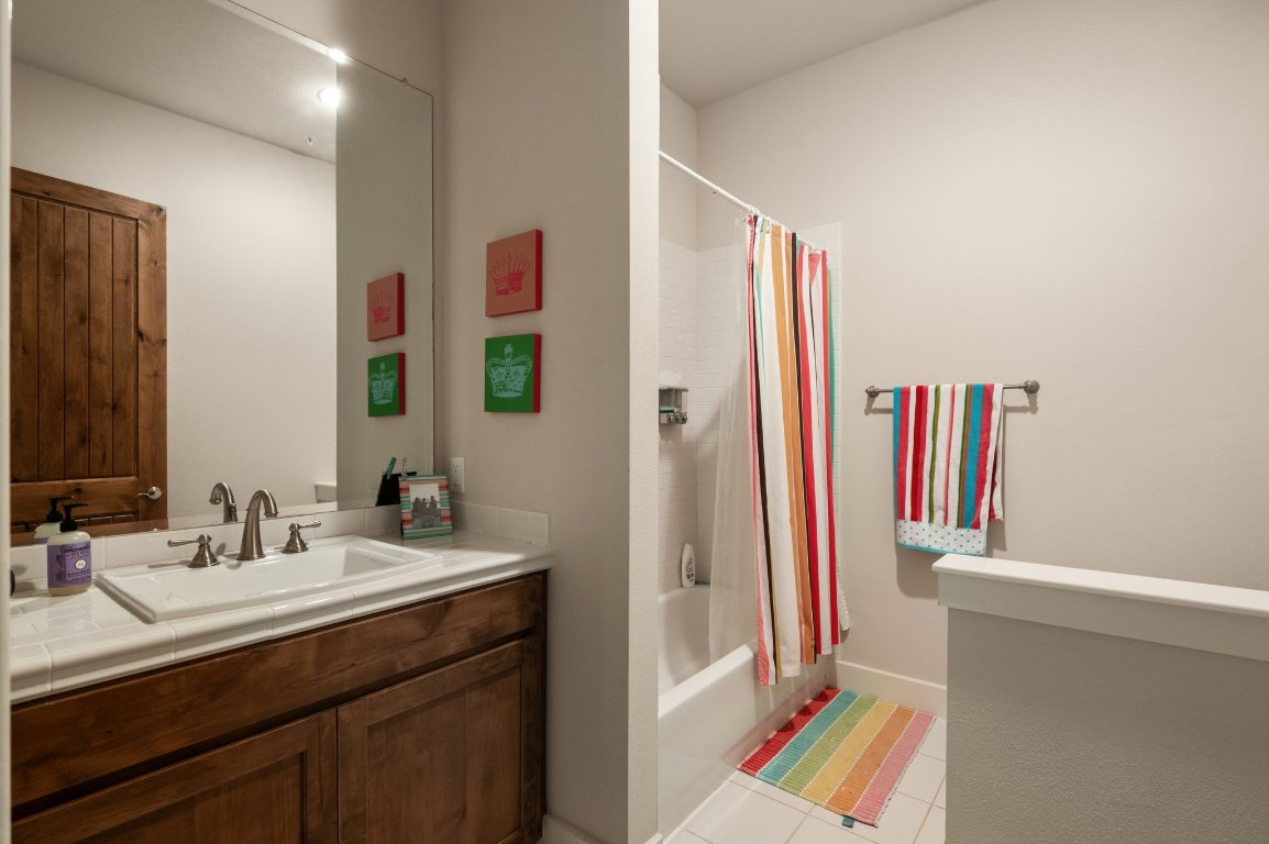 1101 Ivean Pearson Road, Unit E201 Leander, TX 78645 - Photo 18 of 20 a en suite bathroom with a sink and a mirror