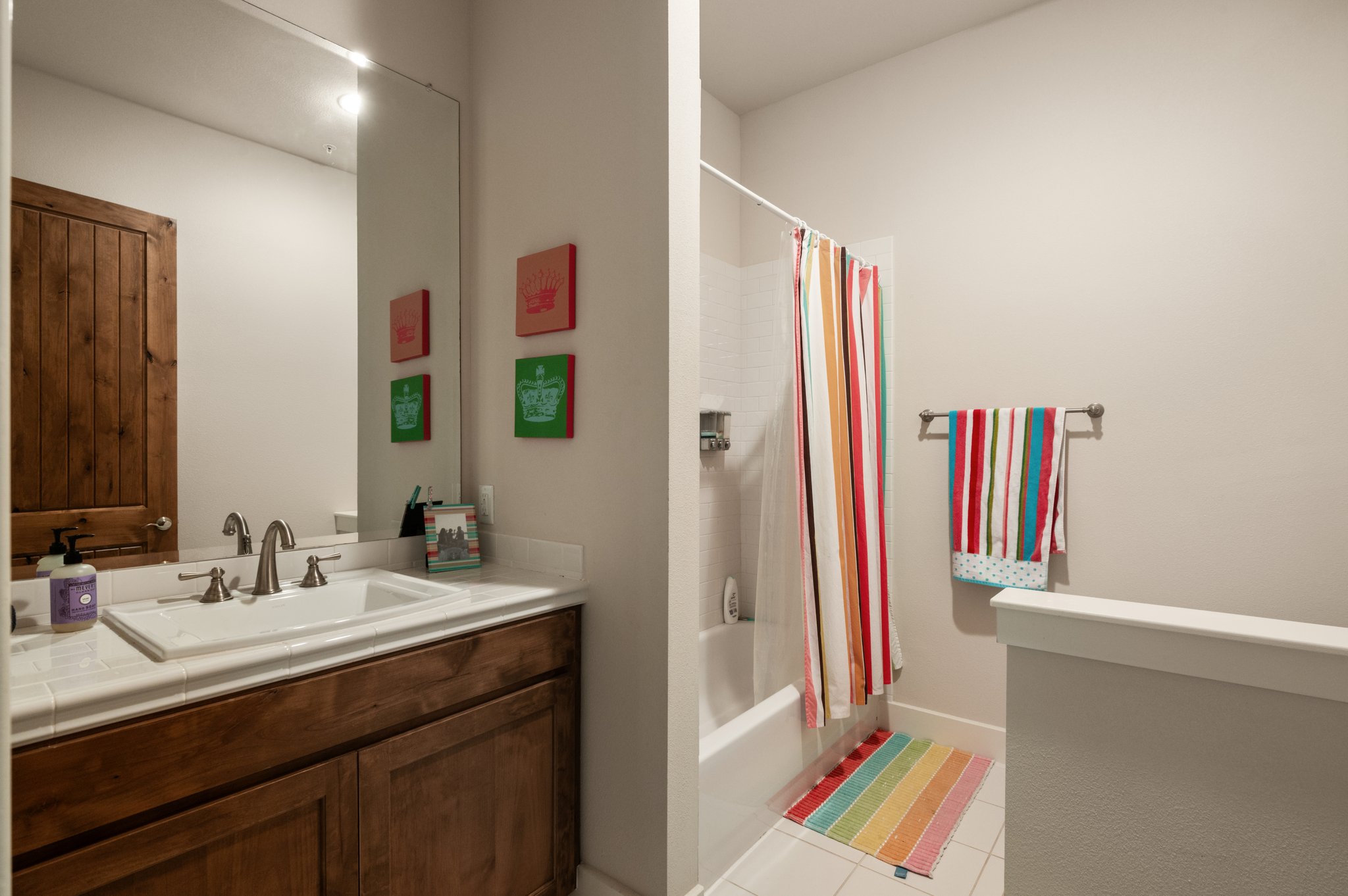 1101 Ivean Pearson Road, Unit E201 Leander, TX 78645 - Photo 18 of 20 Full bathroom featuring vanity, tile patterned floors, and shower / bathtub combination with curtain