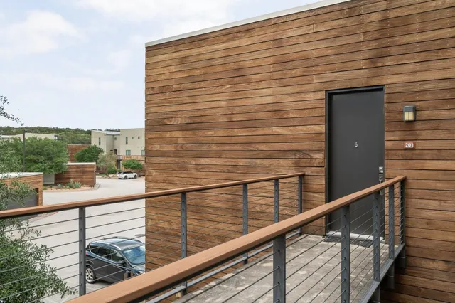 a view of a balcony with a floor to ceiling window and wooden floor