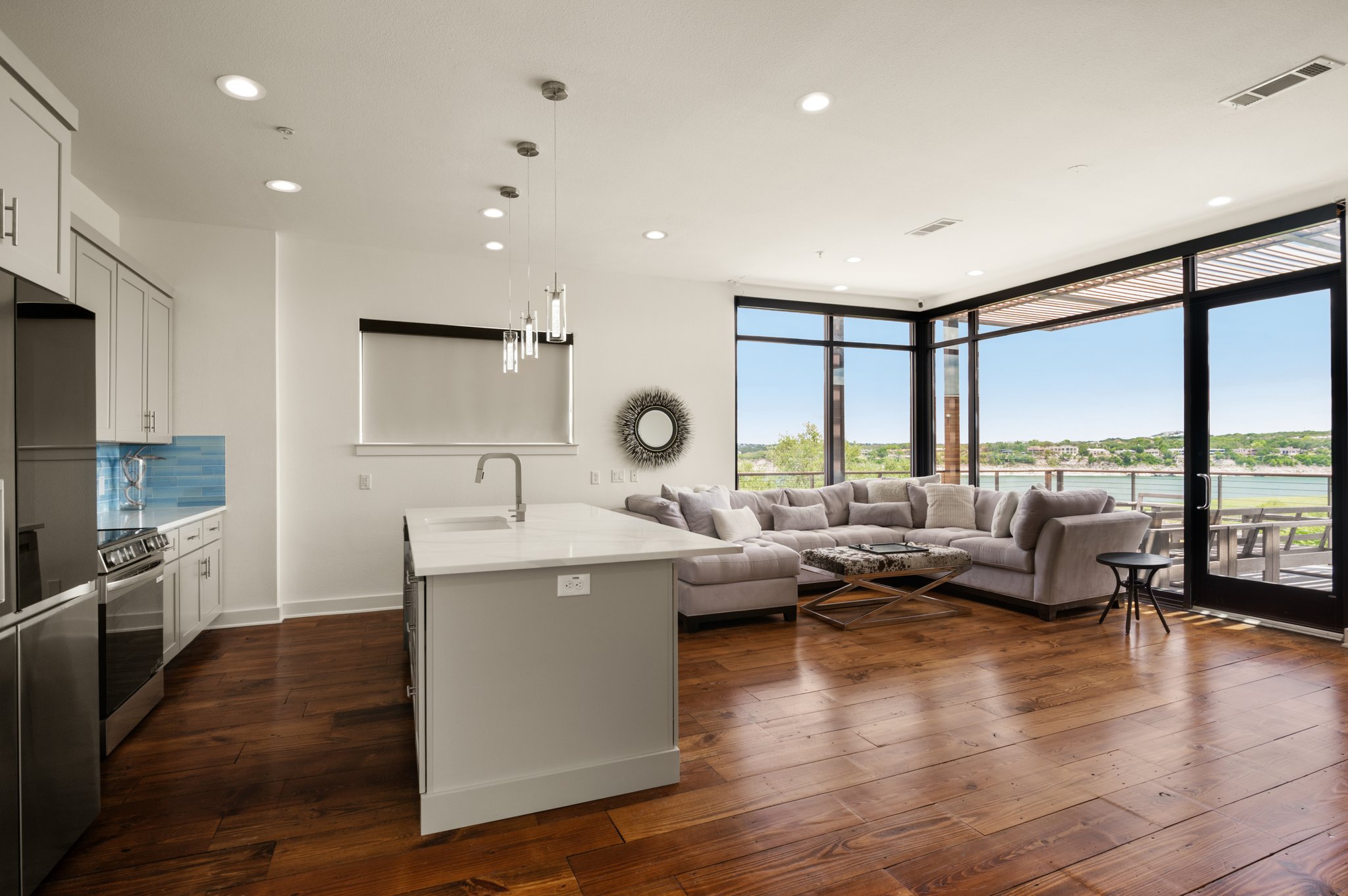 1101 Ivean Pearson Road, Unit E201 Leander, TX 78645 - Photo 20 of 20 Kitchen featuring stainless steel appliances, floor to ceiling windows, a sink, light countertops, and open floor plan