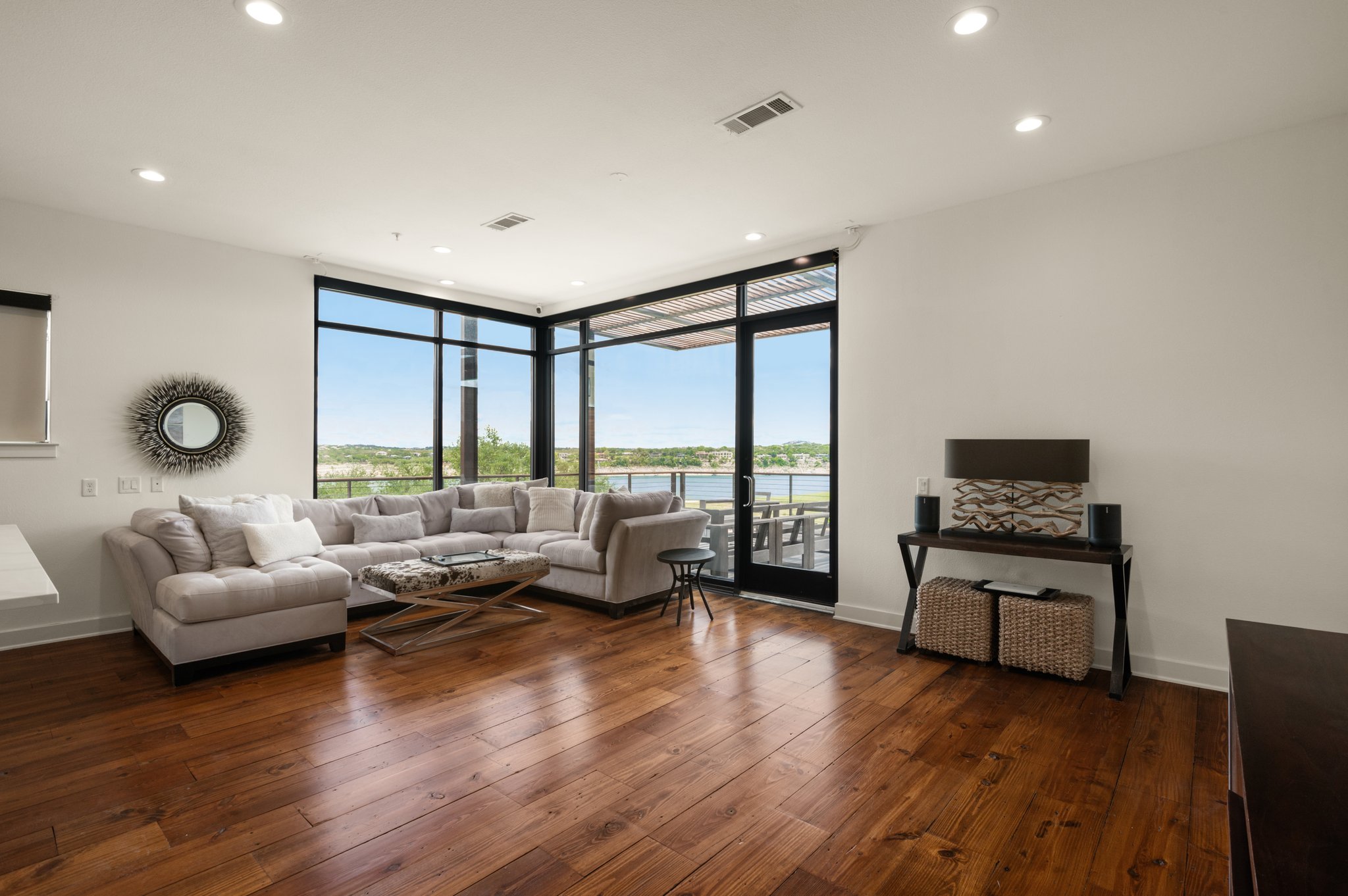 1101 Ivean Pearson Road, Unit E201 Leander, TX 78645 - Photo 2 of 20 Living room with expansive windows, plenty of natural light, wood-type flooring, recessed lighting, and baseboards