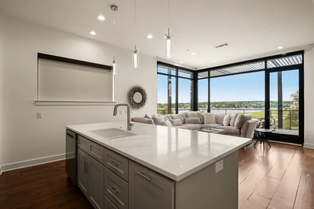 a living room with kitchen island furniture and a large window