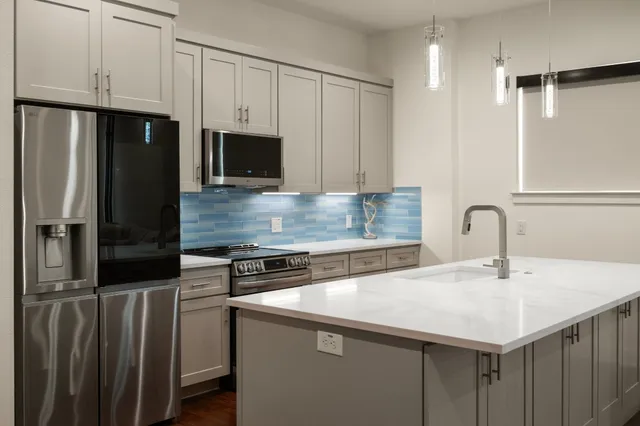 a very nice looking sitting area with kitchen countertops and wooden floor