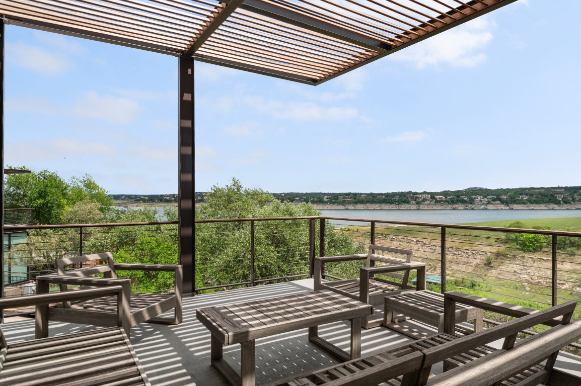 1101 Ivean Pearson Road, Unit E201 Leander, TX 78645 - Photo 7 of 20 a view of a balcony with wooden floor next to a yard