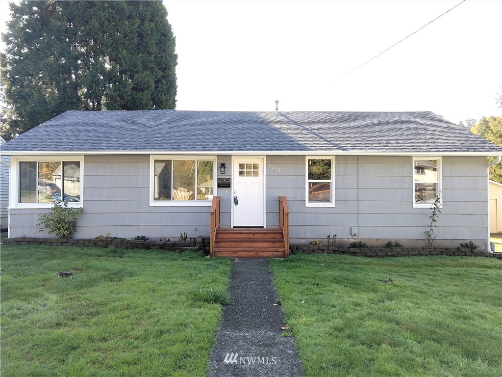 3201 Southeast 5th Street Renton, WA 98058 - Photo 2 of 17 a front view of a house with a garden