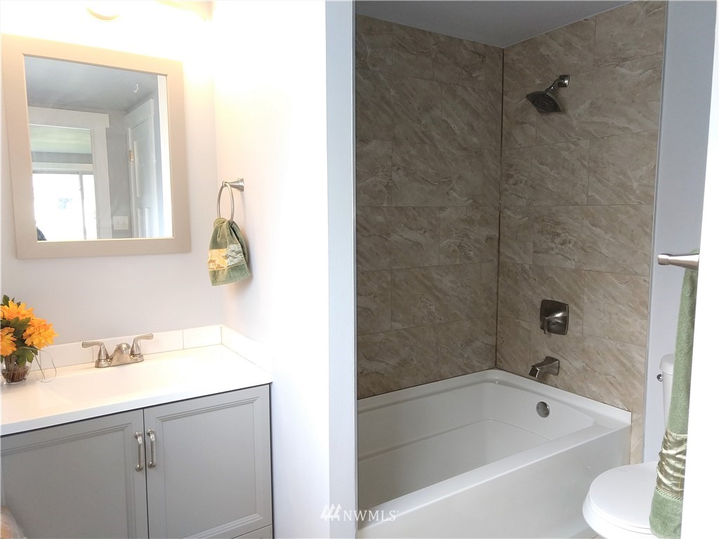 3201 Southeast 5th Street Renton, WA 98058 - Photo 12 of 17 a bathroom with a tub sink and mirror