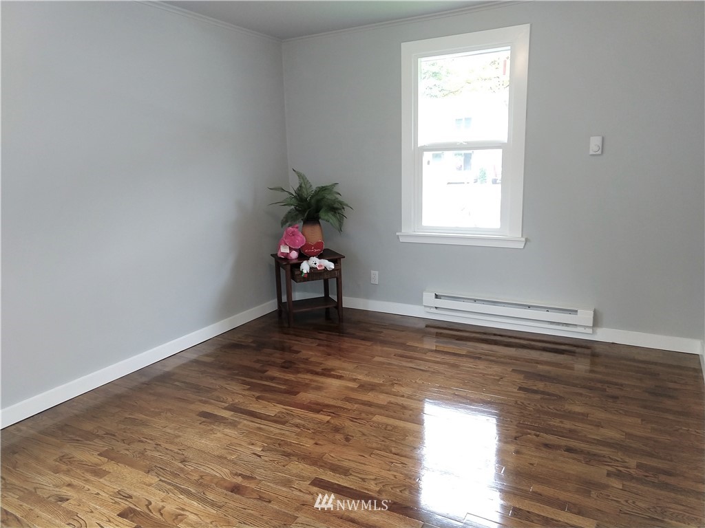 3201 Southeast 5th Street Renton, WA 98058 - Photo 13 of 17 a view of a livingroom with wooden floor and a window