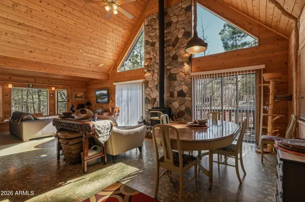 a view of a patio with table and chairs and floor to ceiling window