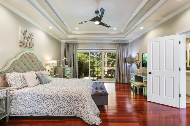 a bedroom with a large bed and a chandelier