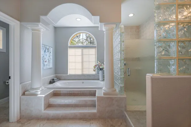a bathroom with a bathtub and a shower