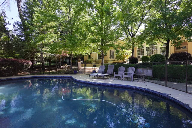 a view of swimming pool with seating space