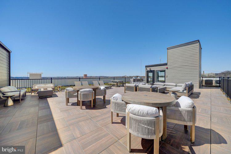 4550 Mitchell Street, Unit 208 Philadelphia, PA 19128 - Photo 14 of 25 a view of a patio with couches and table and chairs with potted plants