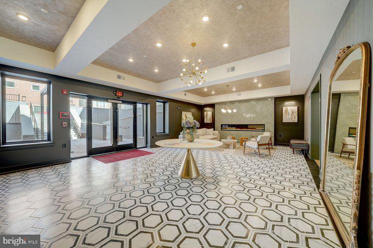 4550 Mitchell Street, Unit 208 Philadelphia, PA 19128 - Photo 18 of 25 a large living room with stainless steel appliances granite countertop a couch and a rug