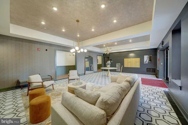 a living room with furniture and a chandelier