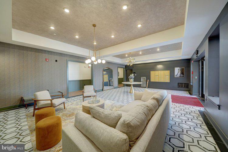 4550 Mitchell Street, Unit 208 Philadelphia, PA 19128 - Photo 19 of 25 a living room with furniture and a chandelier