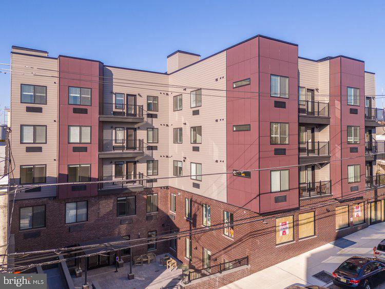 4550 Mitchell Street, Unit 208 Philadelphia, PA 19128 - Photo 23 of 25 a front view of a multi story building