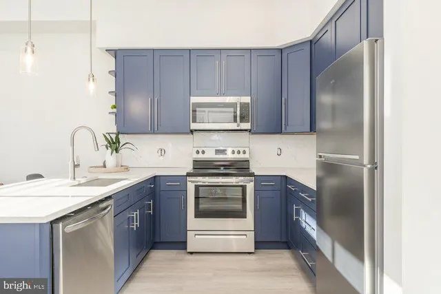 a kitchen with a sink stove and refrigerator