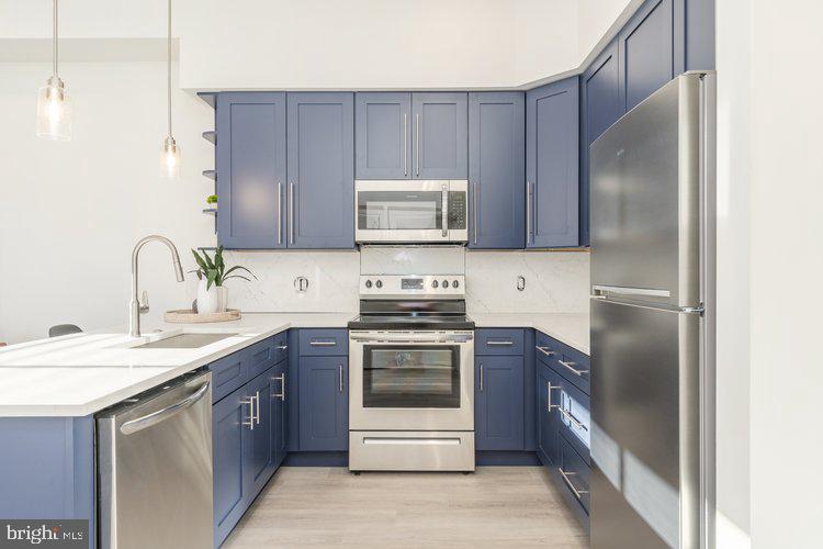 4550 Mitchell Street, Unit 208 Philadelphia, PA 19128 - Photo 5 of 25 a kitchen with a sink stove and refrigerator