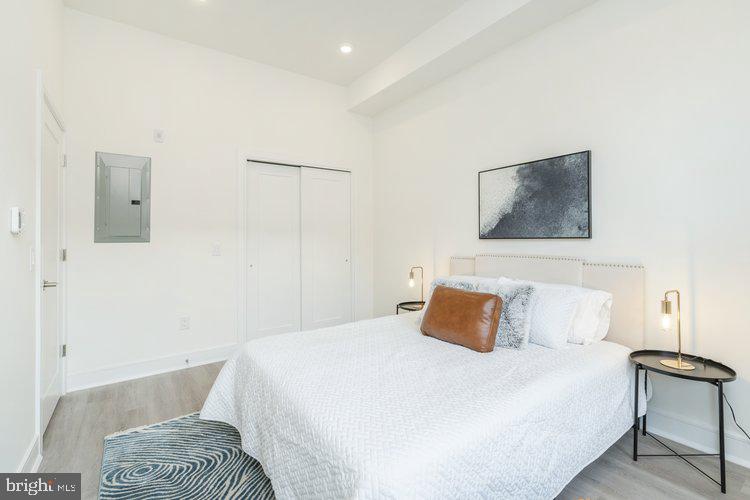 4550 Mitchell Street, Unit 208 Philadelphia, PA 19128 - Photo 9 of 25 a bedroom with a bed and a chair