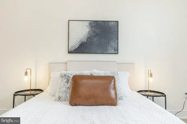 a bedroom with a bed and a lamp on table