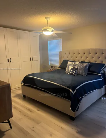 a bedroom with a bed and lamp on desk