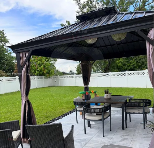 a view of chairs and table in the patio
