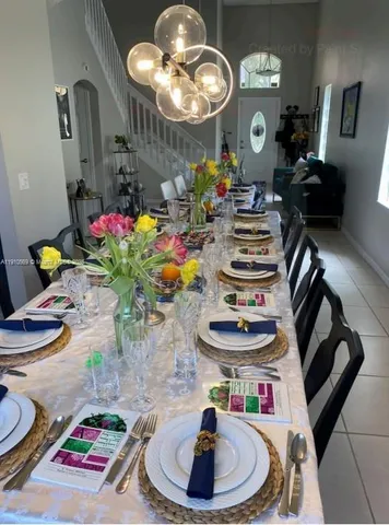 a view of a dining room with furniture and chandelier
