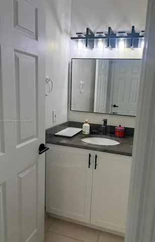 a sink with a mirror and vanity