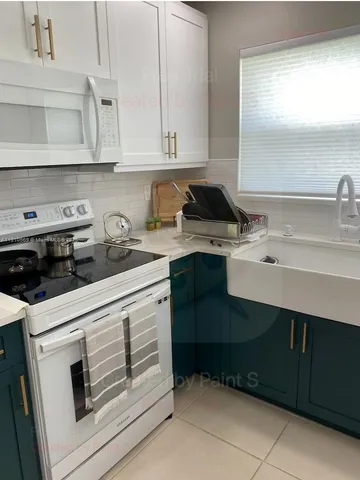 a kitchen with a sink cabinets and appliances