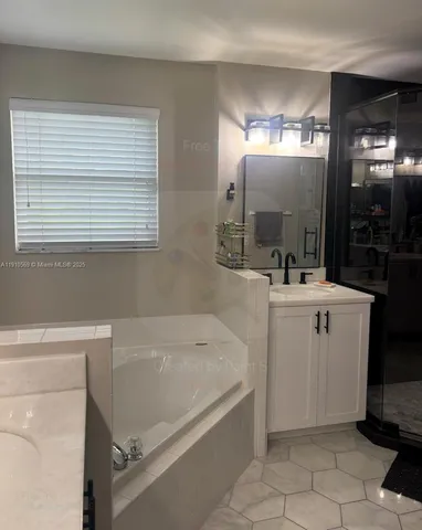 a bathroom with a sink a toilet a mirror and bathtub