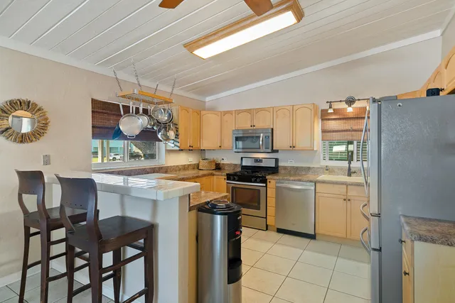 a kitchen with stainless steel appliances granite countertop a refrigerator and a sink